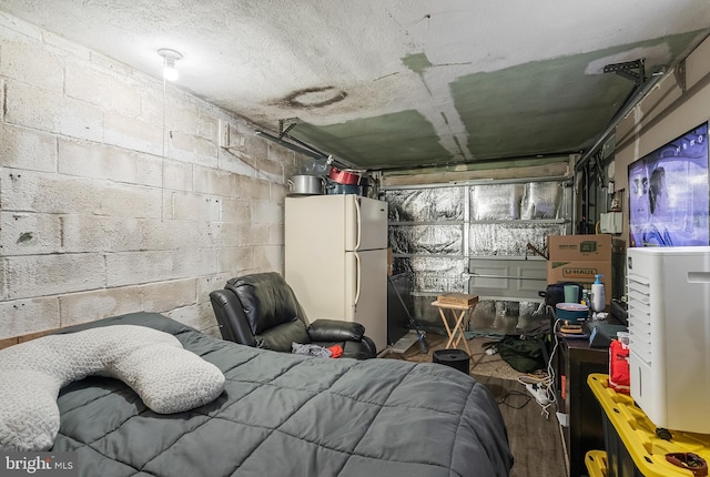 2603 Manall Ave, Pennsauken, NJ 08109 - bedroom with freestanding refrigerator, concrete block wall, and wood finished floors