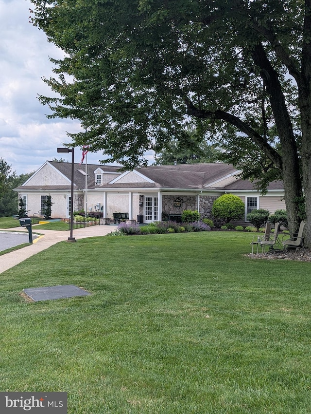 211 Brandon Unit 211, Jeffersonville, PA 19403 - view of front of house with a front yard and stone siding