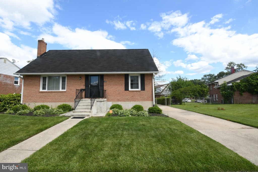 2203 Lukewood Dr, Baltimore, MD 21207 - view of front of house with brick siding, a front yard, a chimney, and roof with shingles