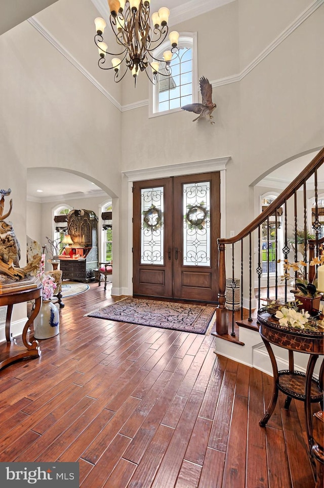 1780 Eliza Way, Mechanicsburg, PA 17050 - entryway featuring arched walkways, a towering ceiling, a chandelier, wood finished floors, and french doors