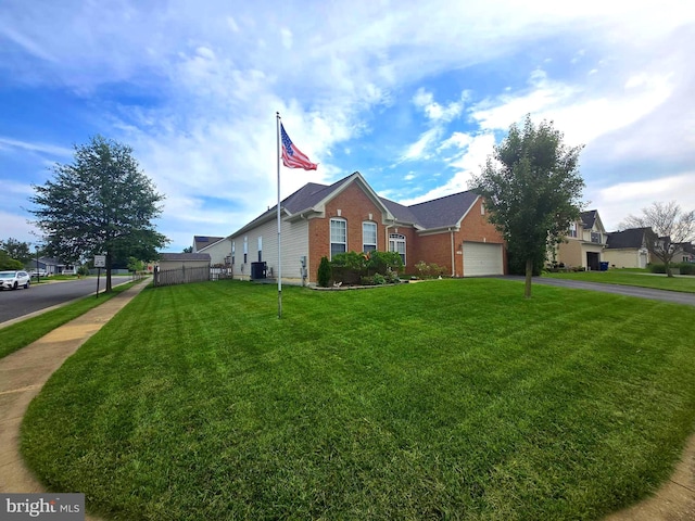122 Lister Ln, Ridgely, MD 21660 - view of front of house with brick siding, central AC, a front yard, asphalt driveway, and an attached garage