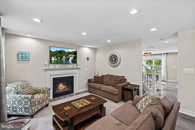 308 Walnut Dr, Fredericksburg, VA 22405 - living room with wood finished floors, a fireplace with flush hearth, stairs, baseboards, and recessed lighting