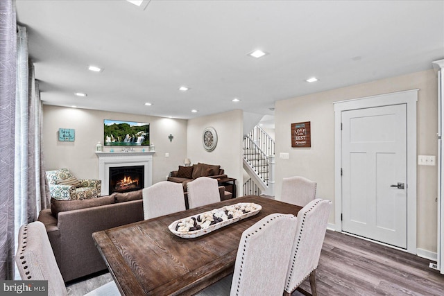 308 Walnut Dr, Fredericksburg, VA 22405 - dining area with wood finished floors, stairway, a lit fireplace, and recessed lighting