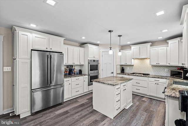 308 Walnut Dr, Fredericksburg, VA 22405 - kitchen with stainless steel appliances, white cabinetry, backsplash, a kitchen island, and recessed lighting