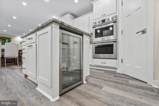 308 Walnut Dr, Fredericksburg, VA 22405 - kitchen featuring stainless steel double oven, light wood-style flooring, white cabinetry, and recessed lighting