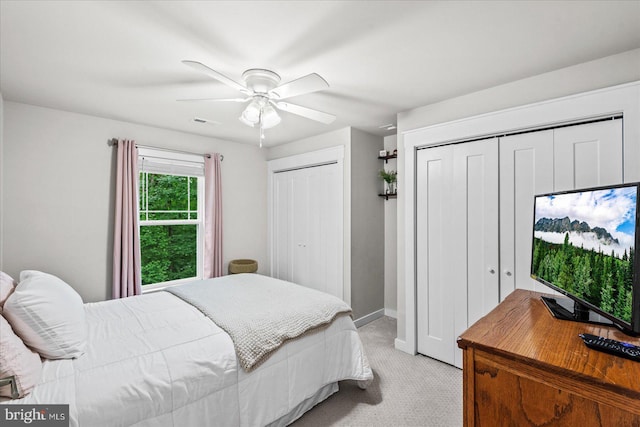 308 Walnut Dr, Fredericksburg, VA 22405 - bedroom with light carpet, two closets, baseboards, and a ceiling fan
