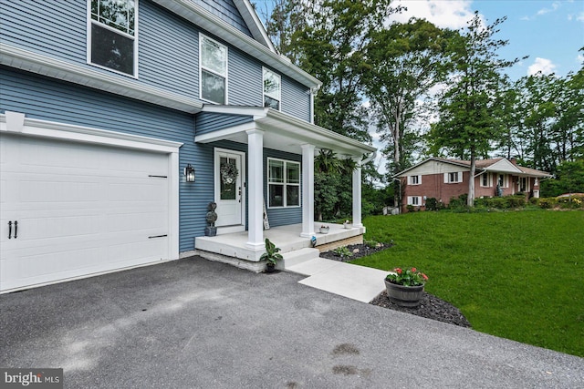 308 Walnut Dr, Fredericksburg, VA 22405 - view of front of home featuring covered porch, a front lawn, a garage, and asphalt driveway