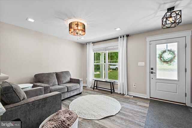 308 Walnut Dr, Fredericksburg, VA 22405 - living area with wood finished floors, a chandelier, and baseboards