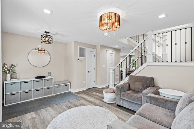 308 Walnut Dr, Fredericksburg, VA 22405 - living room with a chandelier, wood finished floors, stairs, and baseboards