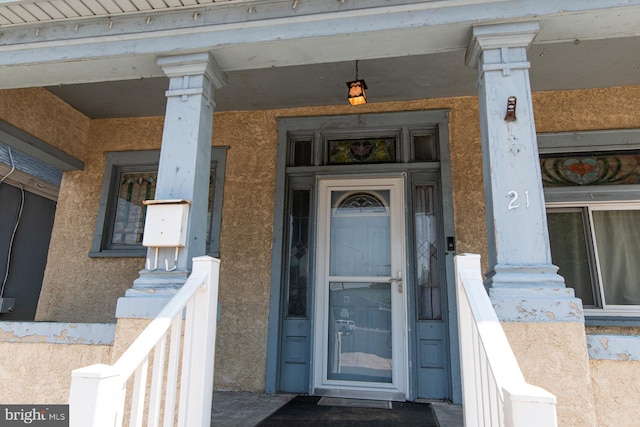 21 E 3rd St, Boyertown, PA 19512 - view of exterior entry featuring stucco siding and a porch
