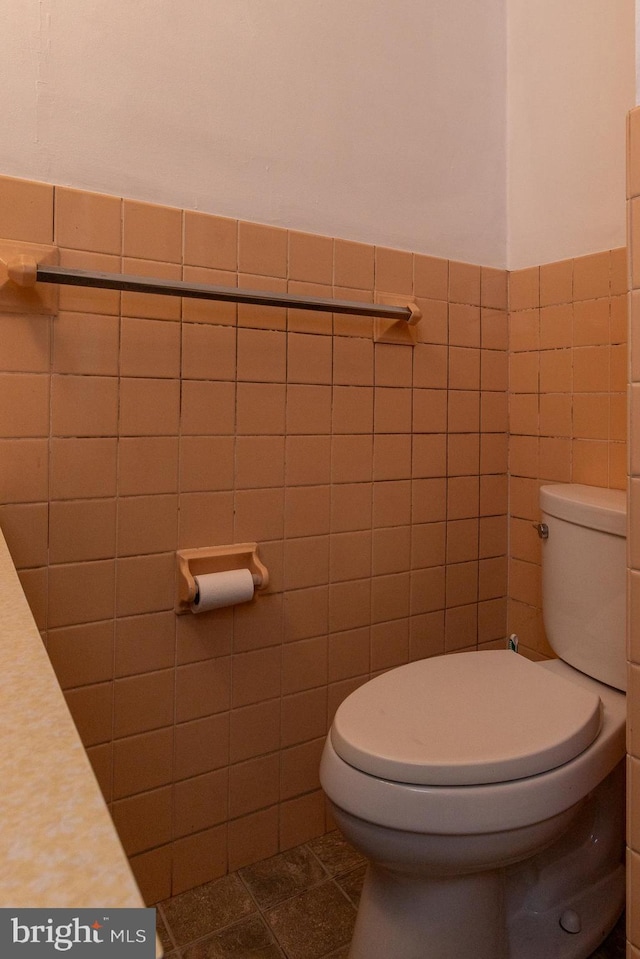 21 E 3rd St, Boyertown, PA 19512 - bathroom featuring tile walls, toilet, a wainscoted wall, and tile patterned flooring