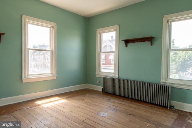 21 E 3rd St, Boyertown, PA 19512 - spare room with radiator heating unit, wood-type flooring, and baseboards