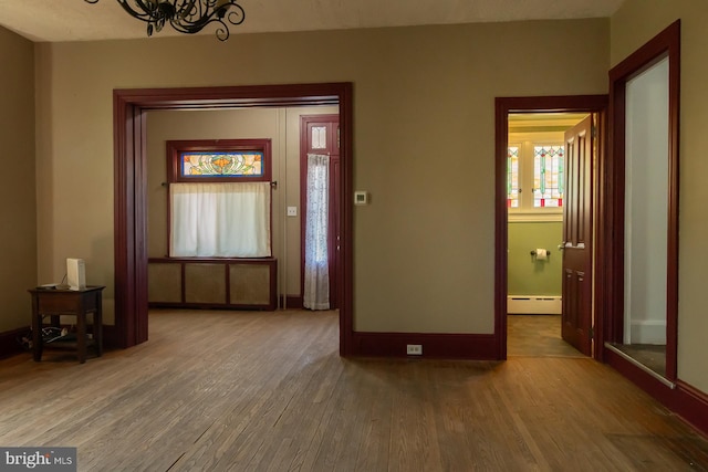 21 E 3rd St, Boyertown, PA 19512 - entryway with a baseboard radiator, a chandelier, wood finished floors, and baseboards