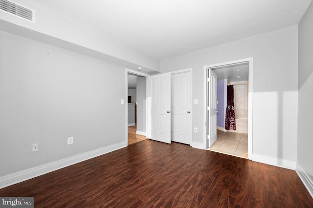 414 Water St Unit 2805, Baltimore, MD 21202 - unfurnished bedroom featuring baseboards, wood finished floors, and ensuite bath