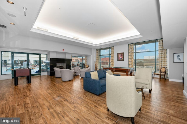 414 Water St Unit 2805, Baltimore, MD 21202 - living room featuring a tray ceiling, billiards, expansive windows, wood finished floors, and baseboards