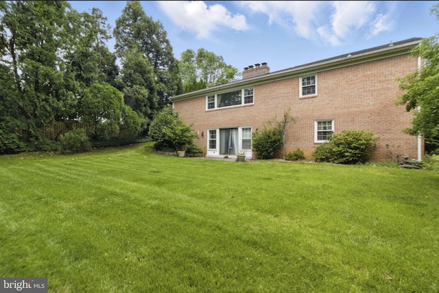 6178 Hardy Dr, Mclean, VA 22101 - back of house with a chimney, a yard, and brick siding