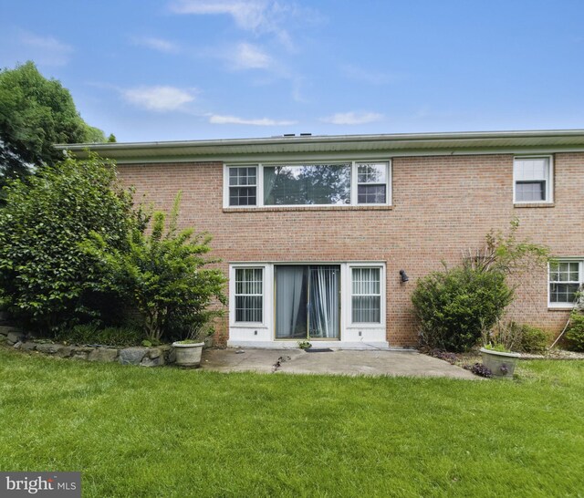 6178 Hardy Dr, Mclean, VA 22101 - rear view of house with a lawn, brick siding, and a patio area