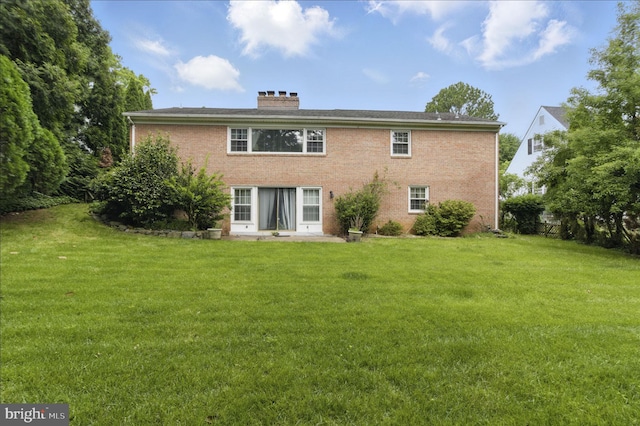 6178 Hardy Dr, Mclean, VA 22101 - back of house featuring a lawn, brick siding, and a chimney