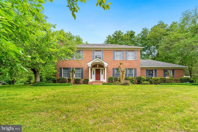 140 Hoile Ln, Huntingtown, MD 20639 - colonial house with brick siding and a front yard