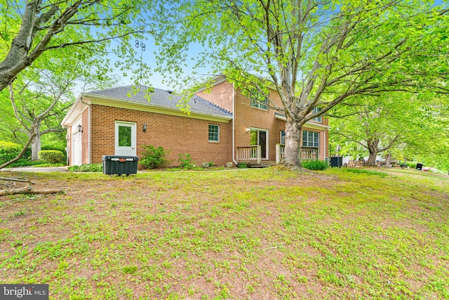 140 Hoile Ln, Huntingtown, MD 20639 - rear view of house featuring brick siding, an attached garage, and central AC