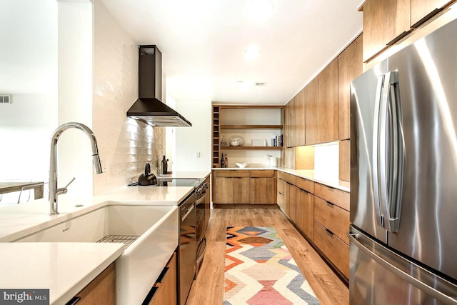3801 Canterbury Rd Unit 705, Baltimore, MD 21218 - kitchen with freestanding refrigerator, wall chimney exhaust hood, brown cabinets, open shelves, and light countertops