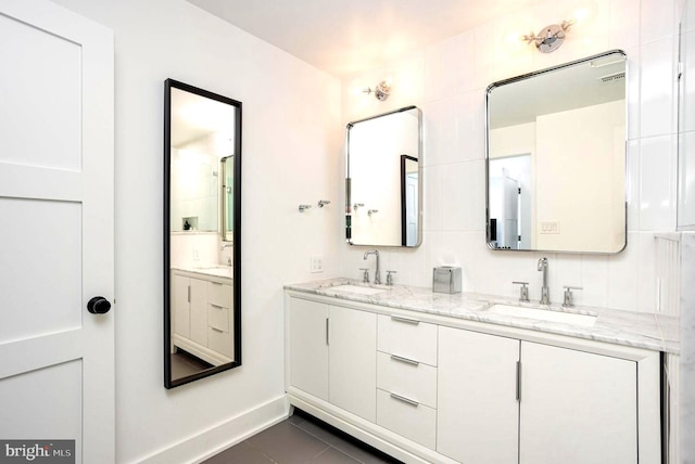 3801 Canterbury Rd Unit 705, Baltimore, MD 21218 - bathroom featuring double vanity, tile patterned floors, and baseboards