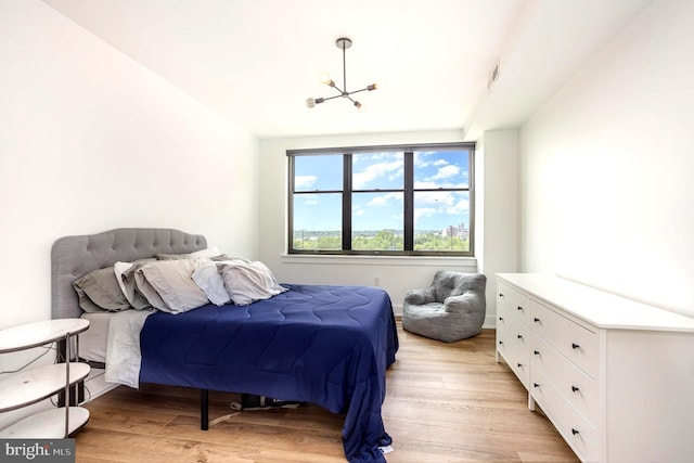 3801 Canterbury Rd Unit 705, Baltimore, MD 21218 - bedroom with a chandelier and light wood-style floors