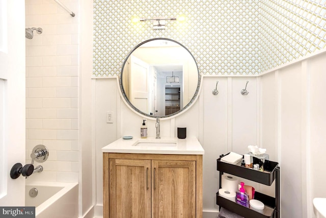 3801 Canterbury Rd Unit 705, Baltimore, MD 21218 - full bathroom featuring a decorative wall, vanity, shower / bathtub combination, wallpapered walls, and a wainscoted wall