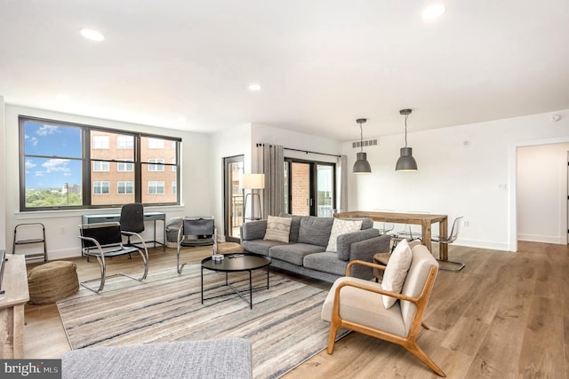 3801 Canterbury Rd Unit 705, Baltimore, MD 21218 - living room featuring healthy amount of natural light, light wood finished floors, baseboards, and recessed lighting
