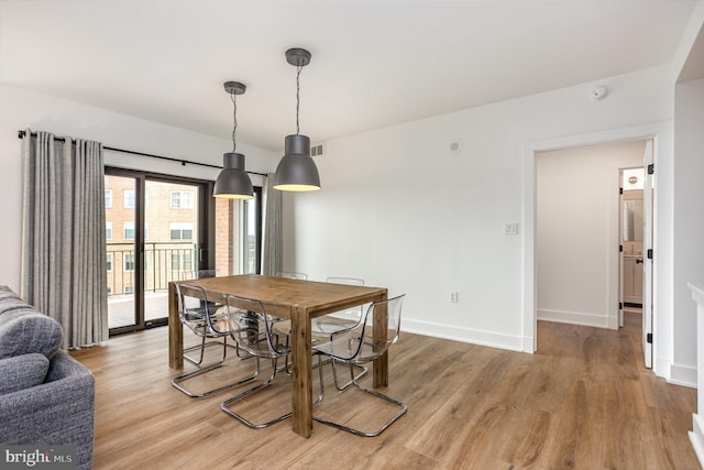 3801 Canterbury Rd Unit 705, Baltimore, MD 21218 - dining room with light wood finished floors and baseboards