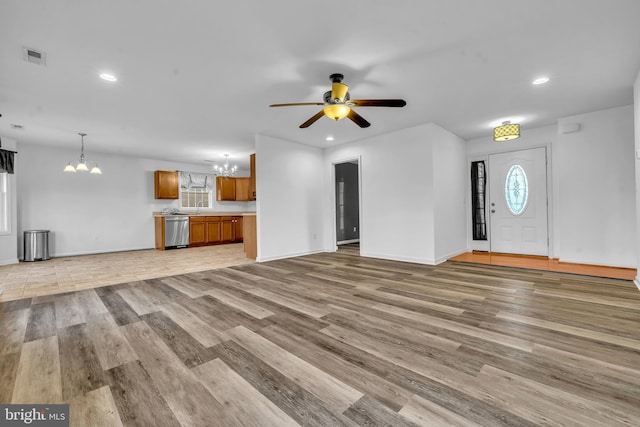 15 Ridgeway Dr, Ridgely, MD 21660 - unfurnished living room featuring a chandelier, a ceiling fan, light wood finished floors, and recessed lighting
