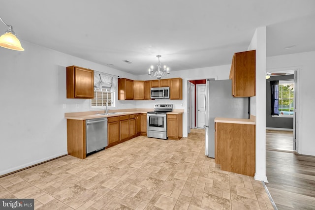 15 Ridgeway Dr, Ridgely, MD 21660 - kitchen with appliances with stainless steel finishes, a chandelier, light countertops, and brown cabinets