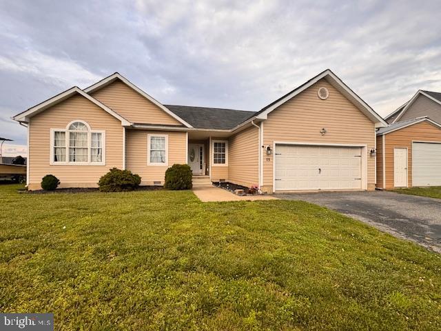 15 Ridgeway Dr, Ridgely, MD 21660 - ranch-style house with driveway, an attached garage, and a front lawn