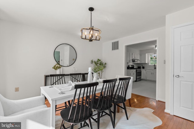 9109 Knox Ct, Laurel, MD 20723 - dining area with a chandelier and light wood-style floors