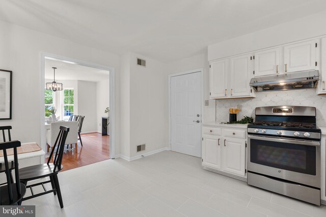 9109 Knox Ct, Laurel, MD 20723 - kitchen with stainless steel range with gas cooktop, under cabinet range hood, tasteful backsplash, white cabinetry, and a chandelier
