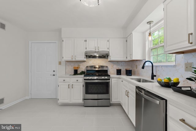 9109 Knox Ct, Laurel, MD 20723 - kitchen with appliances with stainless steel finishes, under cabinet range hood, a sink, light countertops, and white cabinets