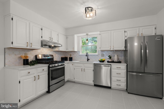 9109 Knox Ct, Laurel, MD 20723 - kitchen with stainless steel appliances, under cabinet range hood, white cabinets, and light countertops