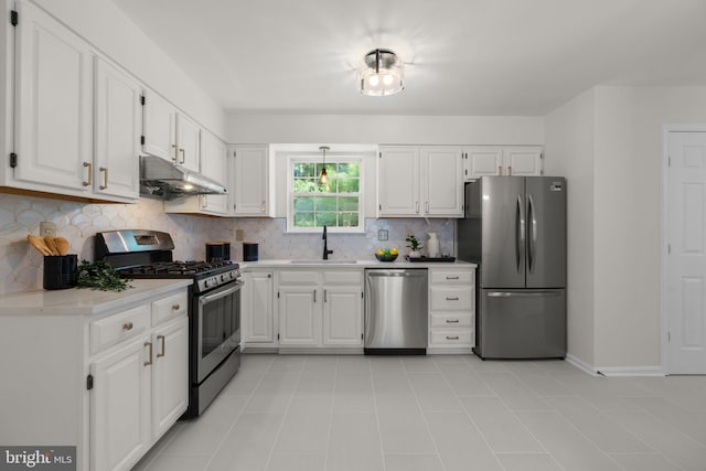 9109 Knox Ct, Laurel, MD 20723 - kitchen with appliances with stainless steel finishes, a sink, under cabinet range hood, backsplash, and light countertops