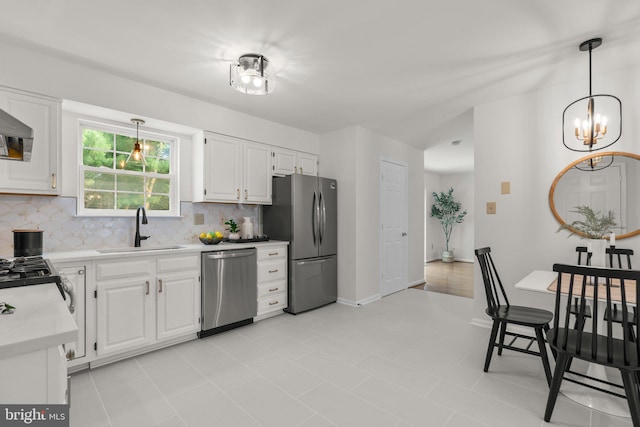 9109 Knox Ct, Laurel, MD 20723 - kitchen featuring stainless steel appliances, a sink, backsplash, and decorative light fixtures