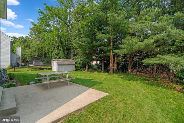 9109 Knox Ct, Laurel, MD 20723 - view of green lawn featuring a trampoline and a patio area