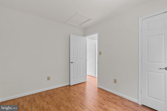 9109 Knox Ct, Laurel, MD 20723 - unfurnished bedroom featuring attic access, light wood-style flooring, and baseboards