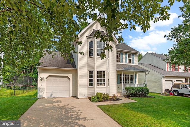9109 Knox Ct, Laurel, MD 20723 - traditional-style house with a trampoline, an attached garage, driveway, covered porch, and a front lawn