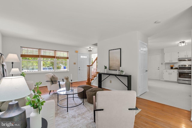 9109 Knox Ct, Laurel, MD 20723 - living area featuring stairs, light wood-style flooring, and baseboards