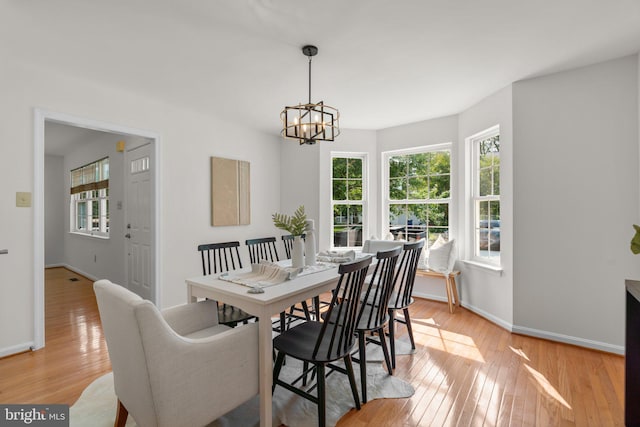 9109 Knox Ct, Laurel, MD 20723 - dining area featuring healthy amount of natural light, light wood-style flooring, a chandelier, and baseboards
