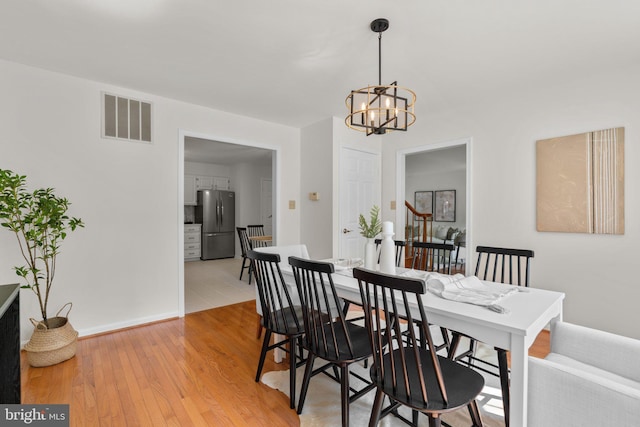 9109 Knox Ct, Laurel, MD 20723 - dining space with a chandelier, light wood finished floors, and baseboards
