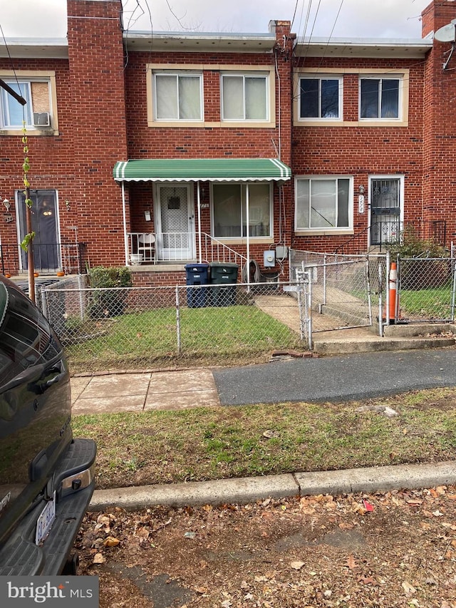1476 Bangor St SE, Washington, DC 20020 - townhome / multi-family property with brick siding, a fenced front yard, and a chimney