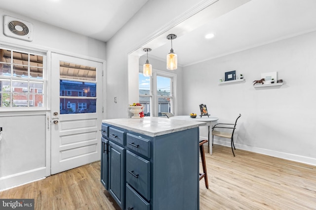 2134 Firethorn Rd, Middle River, MD 21220 - kitchen featuring blue cabinets, a breakfast bar area, light wood-style flooring, light countertops, and decorative light fixtures