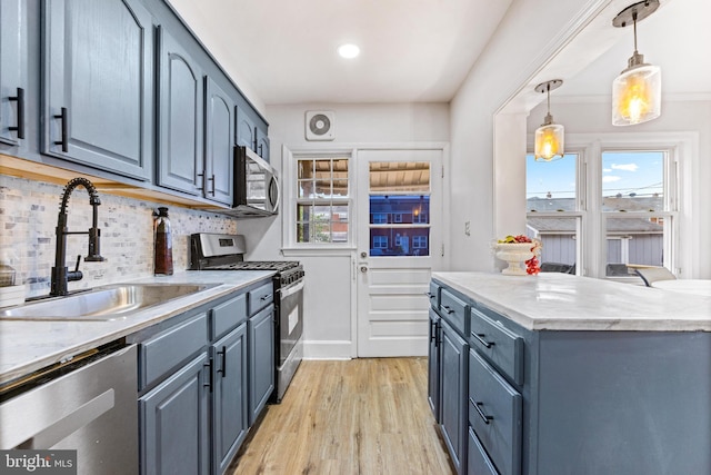 2134 Firethorn Rd, Middle River, MD 21220 - kitchen featuring appliances with stainless steel finishes, light wood-style flooring, backsplash, and plenty of natural light