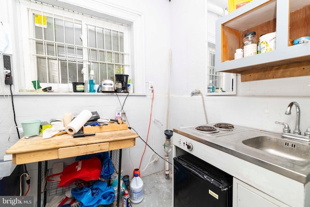 2308 N Park Ave, Philadelphia, PA 19132 - kitchen with white cabinetry, plenty of natural light, concrete floors, and a sink