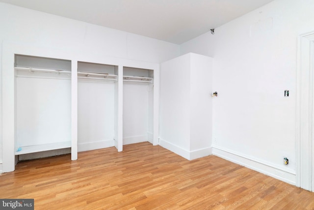 2308 N Park Ave, Philadelphia, PA 19132 - unfurnished bedroom with light wood-style floors, two closets, and baseboards